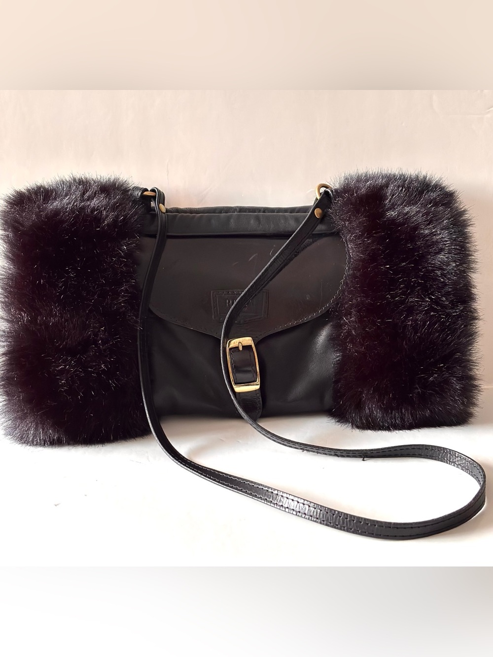 Vintage muff bag made of black leather and faux fur